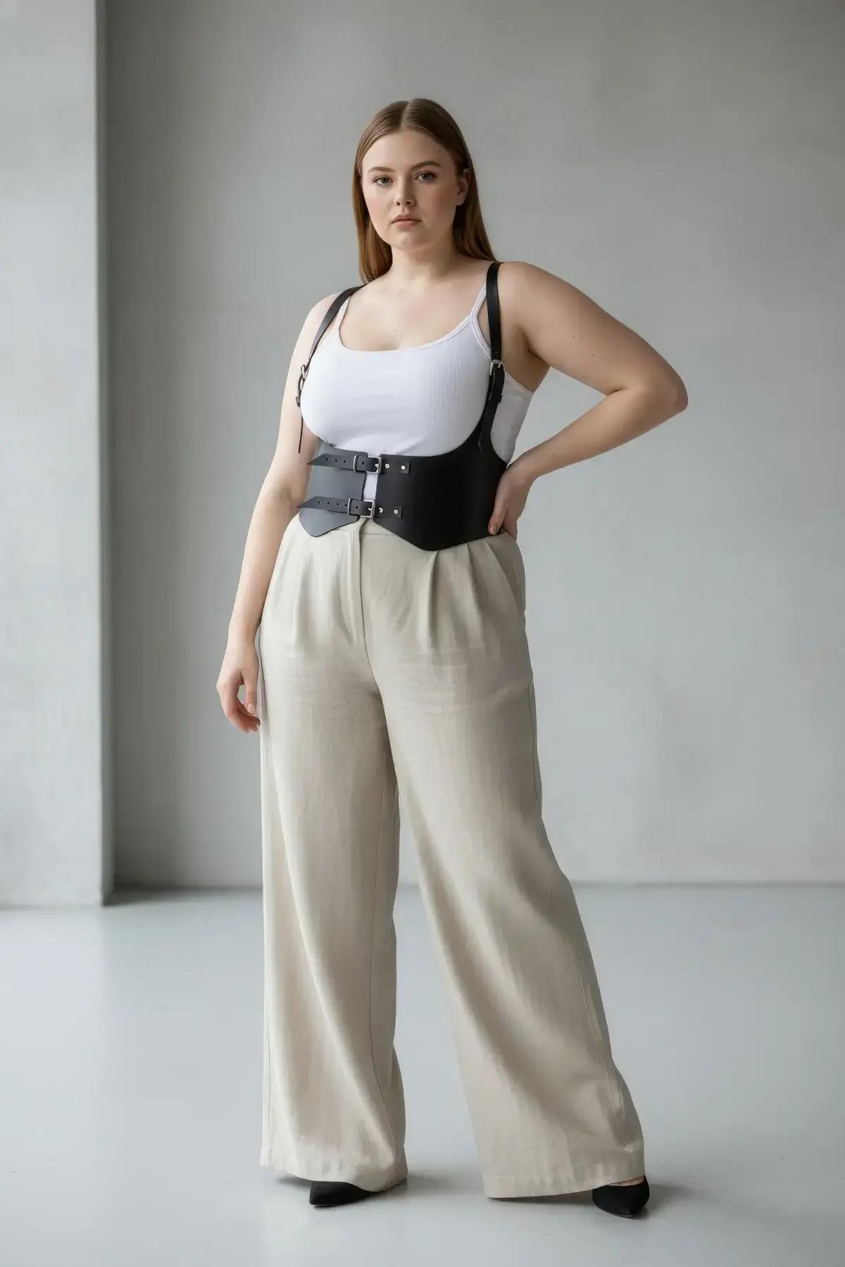 close-up of silver-tone front buckle on black PU vegan leather underbust cincher with structured waist band