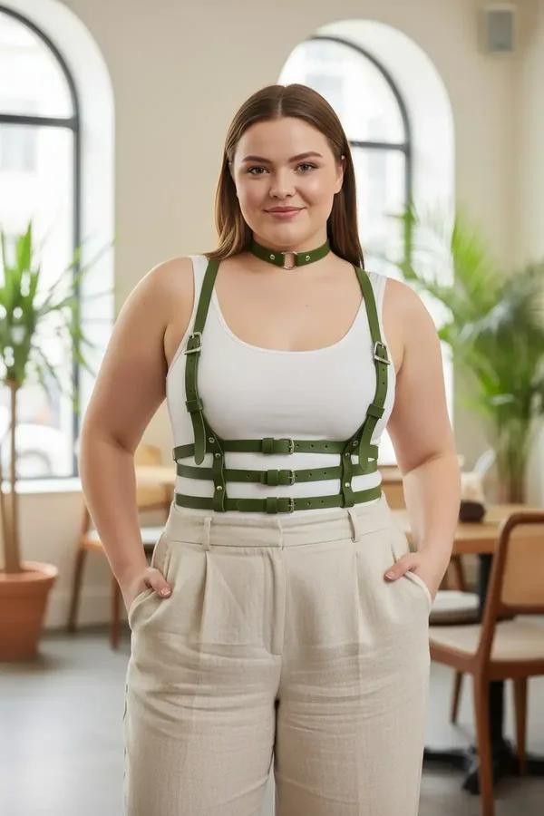 Olive green faux leather chest harness with matching choker and silver buckles worn over white tank top