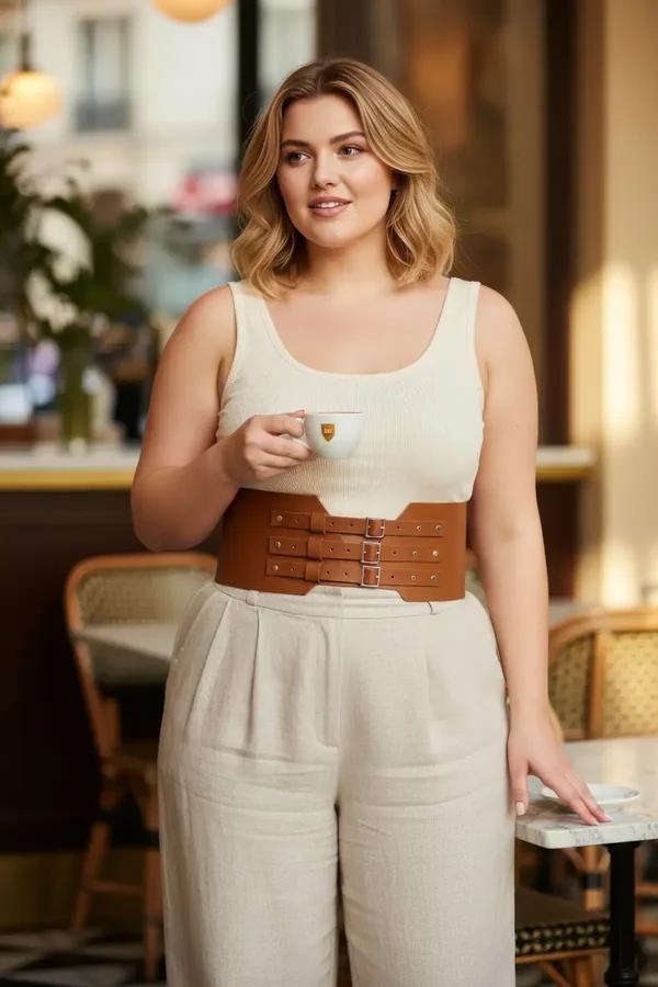 tan faux leather wide corset waist harness with three gold-tone adjustable buckle straps worn over cream top