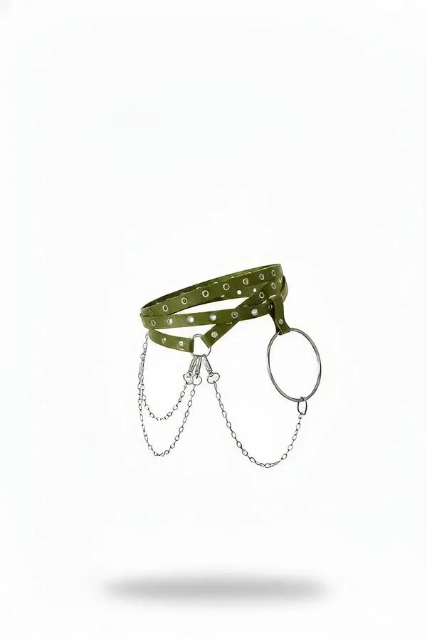 Olive green faux leather waist harness with silver grommets, draped chains, and large O-ring, front view