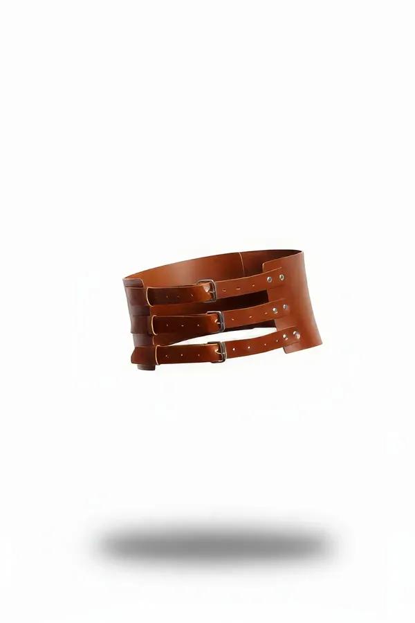 Wide tan vegan leather corset belt with three silver rectangular buckle straps and structured curved panel