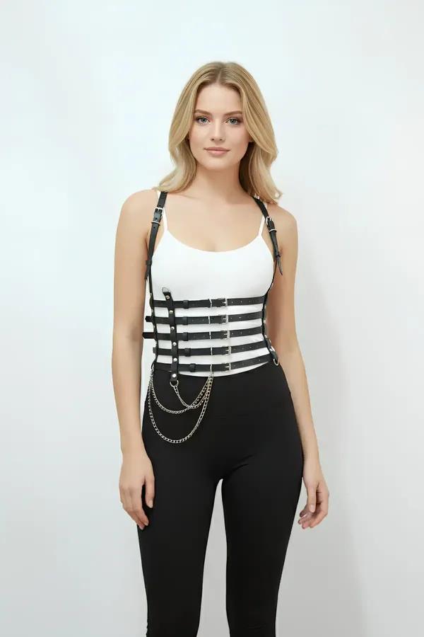 black faux leather multi-strap waist harness with silver buckles and detachable drape chain worn over white tank top