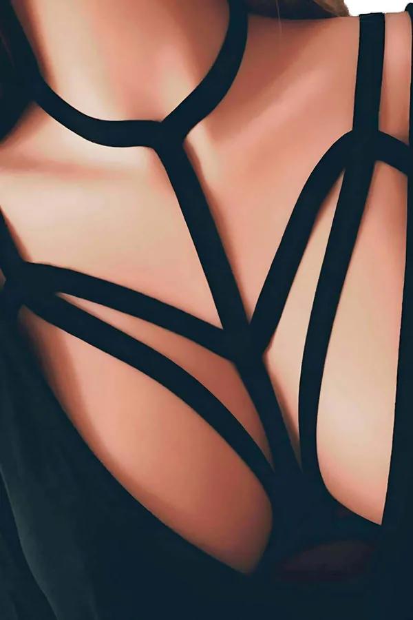Black elastic chest harness, multi-strap elastic structure fanning out in V arrangement from neck ring close-up