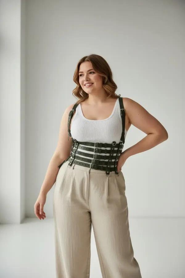 Forest green faux leather wide caged waist harness with five horizontal straps and silver buckle shoulder straps worn over wh