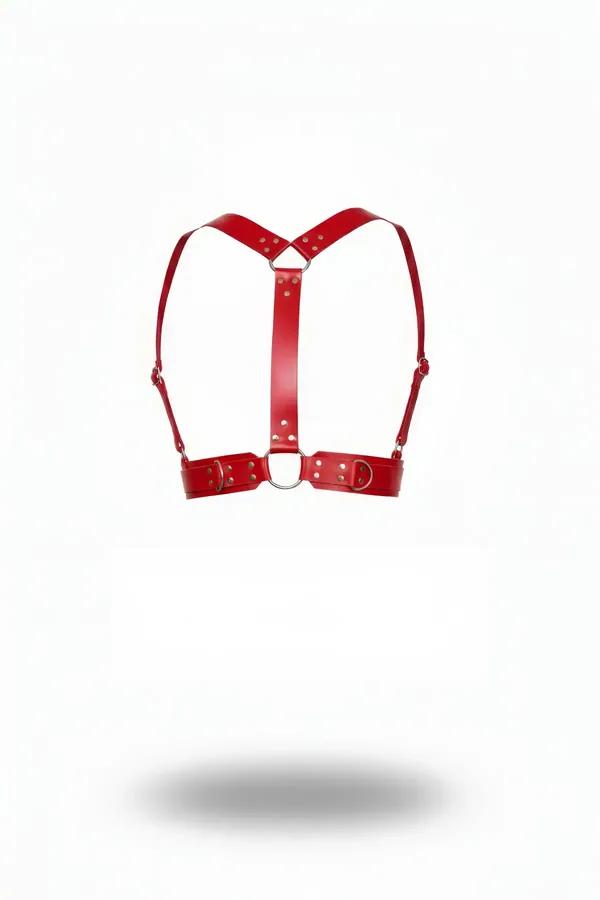 Red faux leather shoulder harness with silver O-ring and adjustable buckle straps on white background