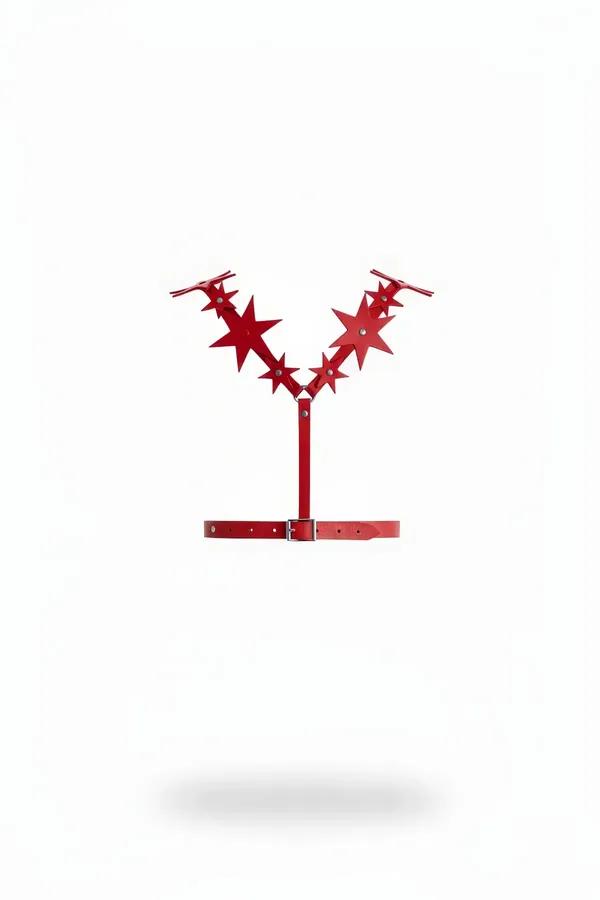 Red faux leather star burst chest harness with V-formation star panels and silver-buckle adjustable waist belt, flat lay on w