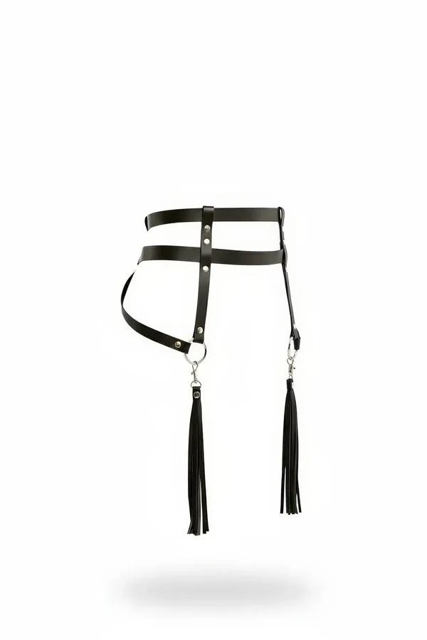 Black faux leather hip harness with dual hanging tassels and silver O-rings, flat product shot on white background