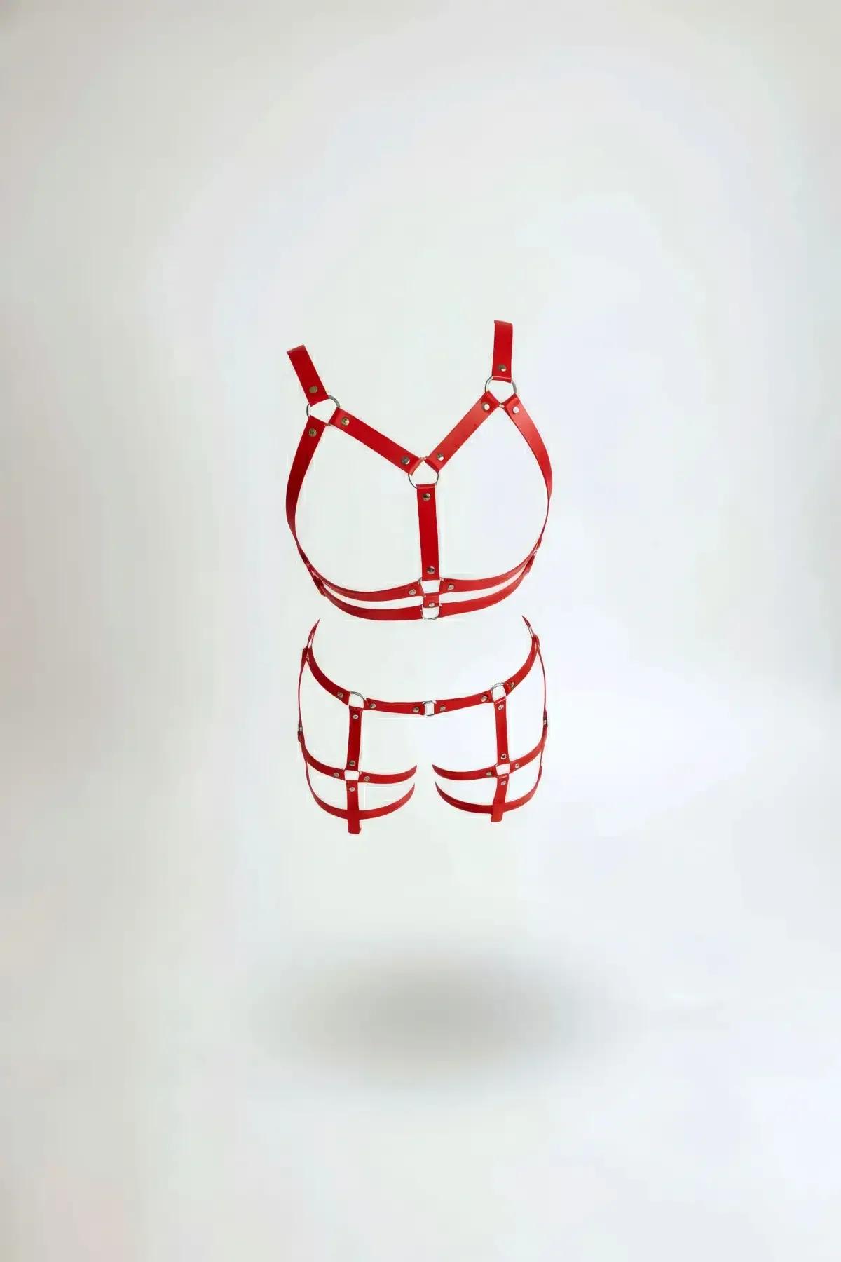 Red faux leather chest harness and cage garter belt set with silver O-rings and stud rivets on white background