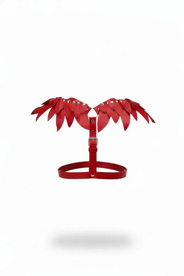Red faux leather winged chest harness with layered feather-leaf panels and silver dome rivets on white background