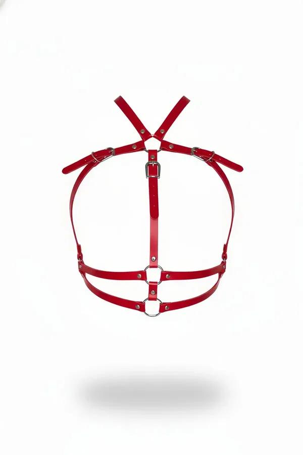 Red faux leather chest harness with dual silver O-rings and X-cross shoulder straps, front view on white background