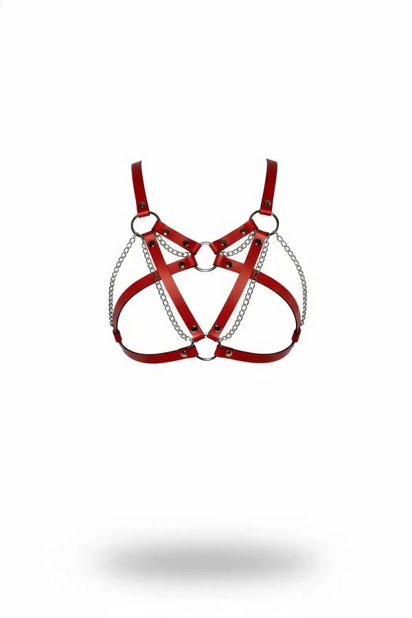 Red faux leather strappy harness bra with silver O-rings and draped chains on white background