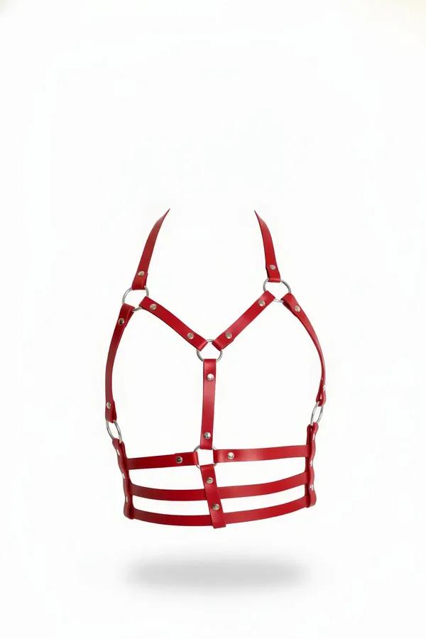 Red faux leather underbust cage harness with silver O-rings and triple waist band straps, front view on white background