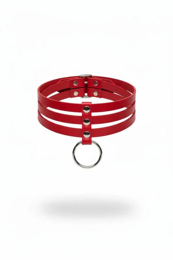 Red triple strap faux leather choker with silver rivets and hanging O-ring pendant on white background