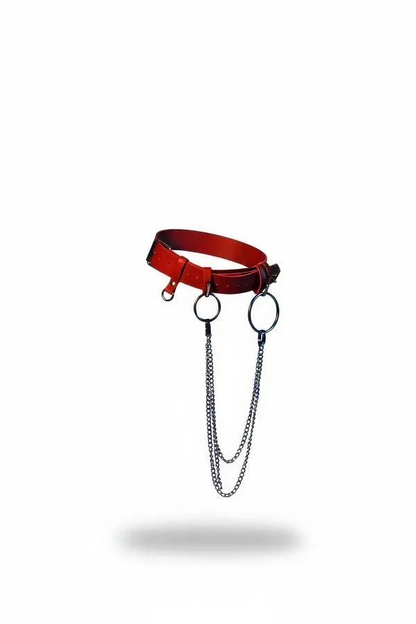 Red faux leather waist belt harness with dual gunmetal O-rings and double-strand draped chains on white background