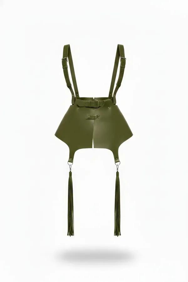 Khaki faux leather skirt harness with flared hip panels, adjustable shoulder straps, silver buckles, and long matching tassel