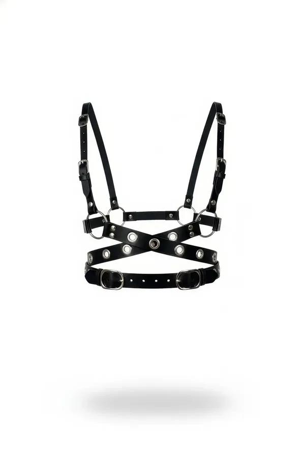 Black faux leather X-cross chest harness with silver grommets, O-rings, and adjustable buckle straps on white background