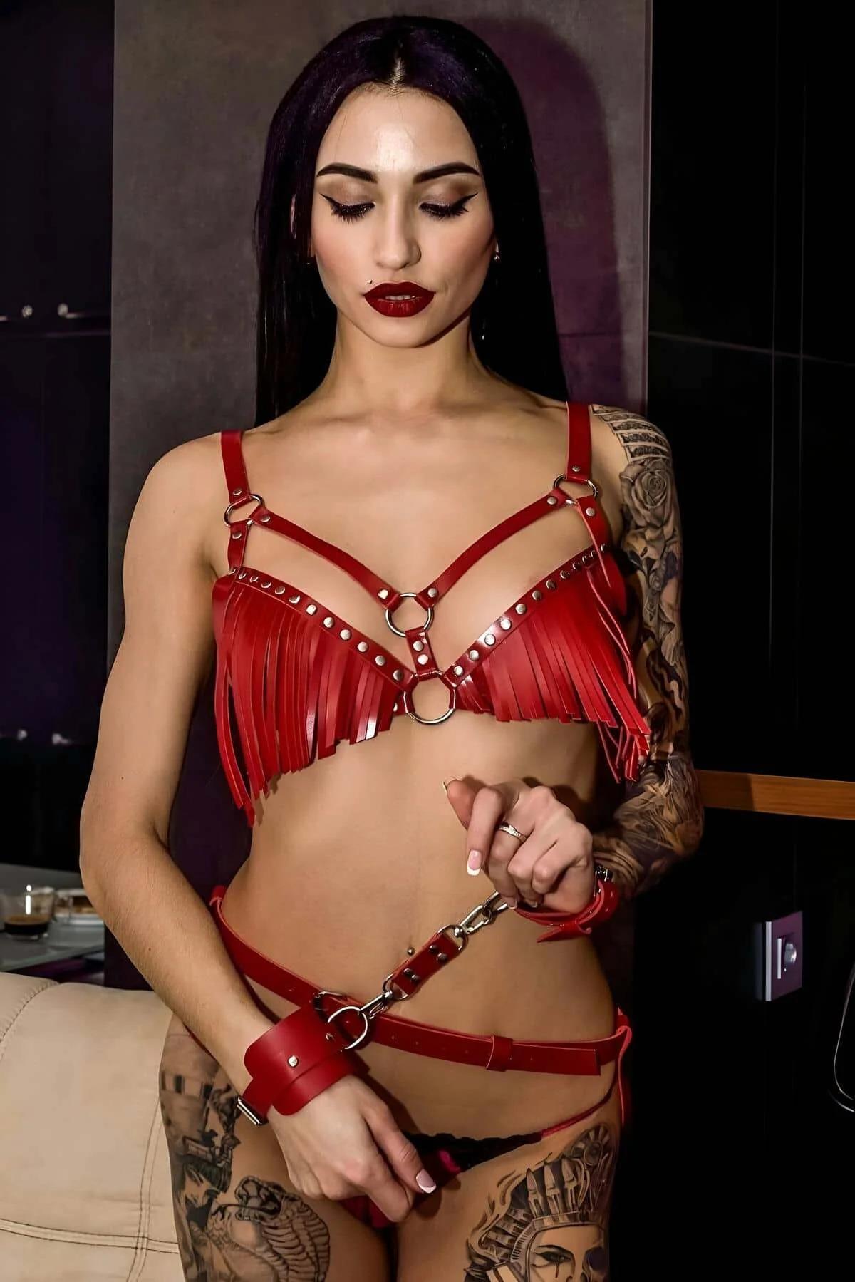 Full red fringe chest harness set laid flat showing collar, harness, hip belt, and cuffs