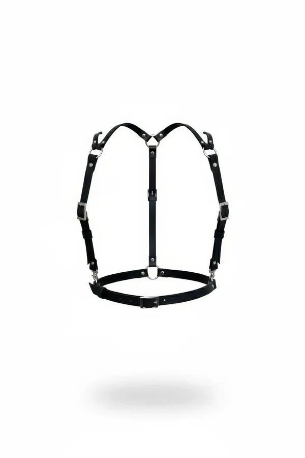 black faux leather adjustable strappy chest harness with silver-tone front O-ring and multiple pin buckles, flat lay on white