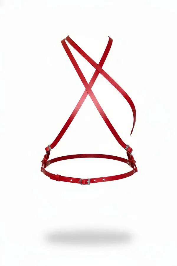 Red faux leather chest harness with X-back crossing straps and silver buckle closures on white background