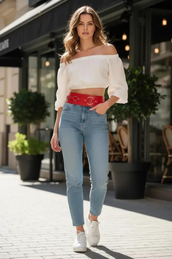 Red faux leather wide waspie belt with three silver O-rings worn over light wash jeans and white crop top