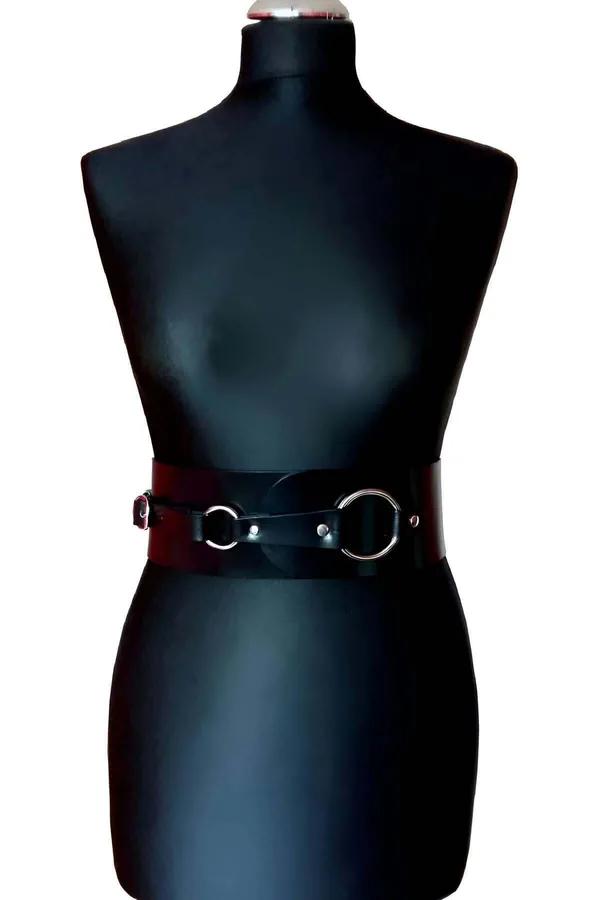 Burgundy wide faux leather waist belt with two silver O-rings on black mannequin front view