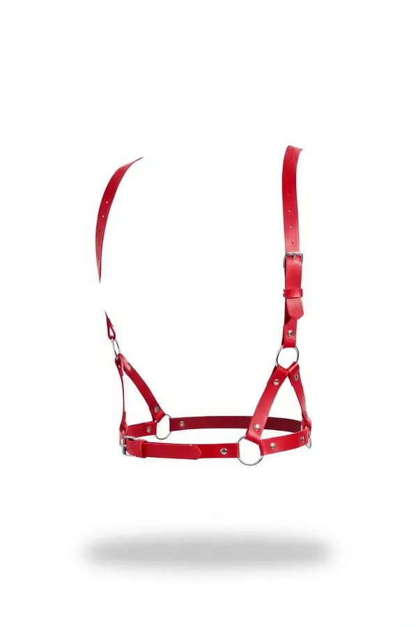 Red faux leather O-ring chest harness bra with silver buckles and three O-rings on white background