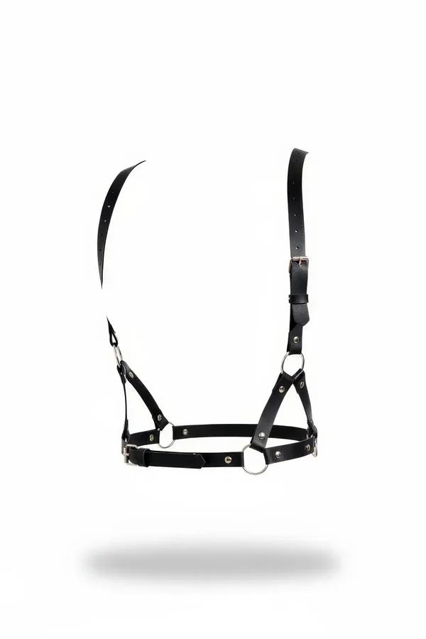 Black vegan leather chest harness with silver O-rings and adjustable shoulder straps, product flat lay on white background