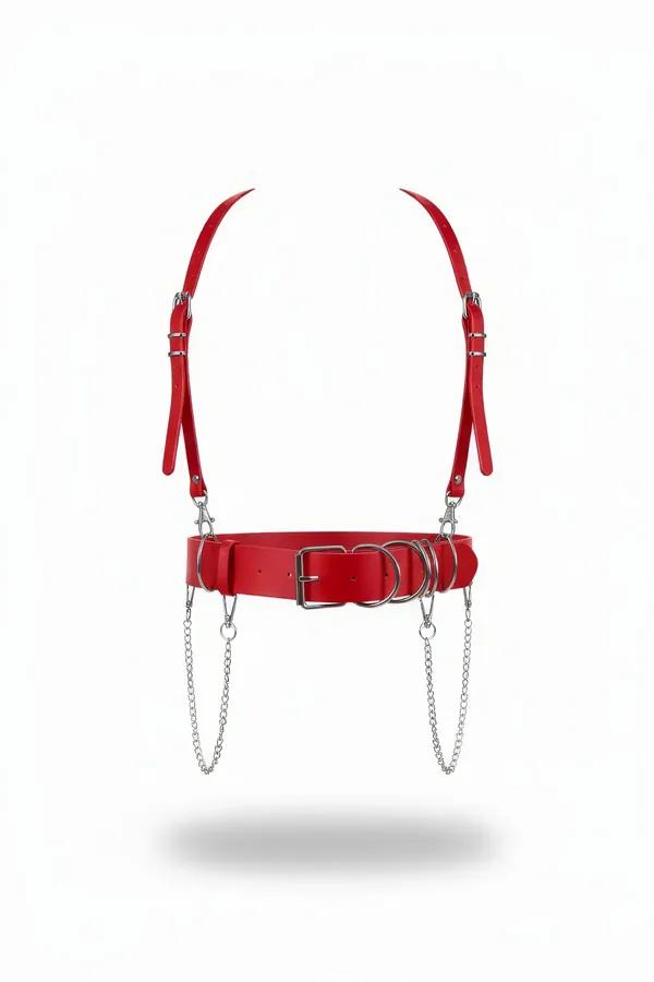 Red faux leather waist harness with silver O-rings, dual draped chains, and adjustable shoulder straps on white background