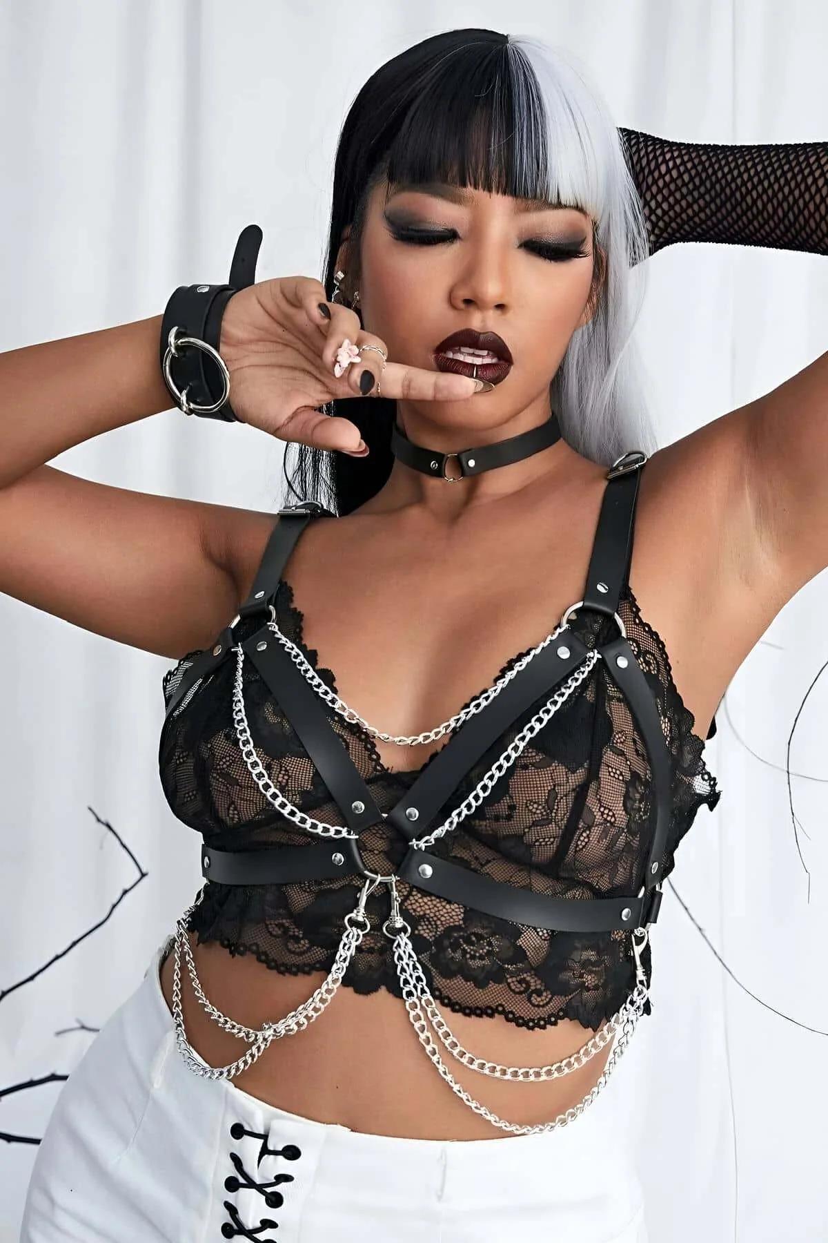 adjustable D-ring shoulder strap detail on black PU leather chest harness with silver studs