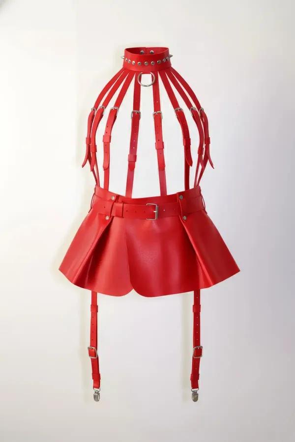 Red faux leather caged body harness skirt set with studded choker, silver buckles, and four garter strap clips