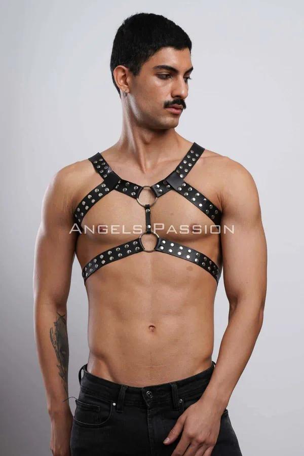 Black studded faux leather full body harness with dual gold O-rings on male model, chest-to-waist coverage
