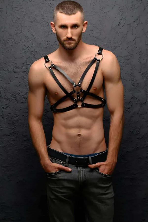 black faux leather chest harness with three silver O-rings and X-cross strap configuration on male model