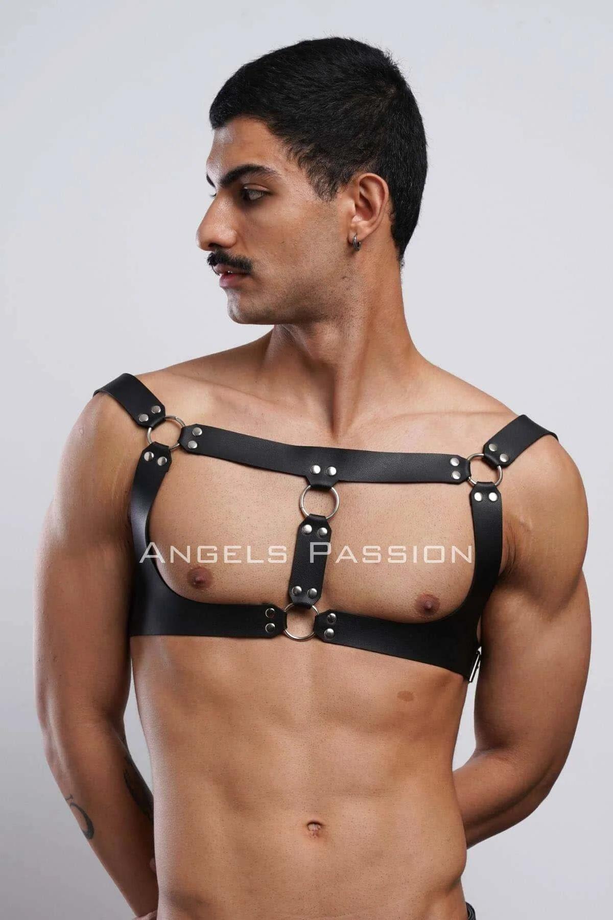 Side angle of black faux leather men's chest harness with wide shoulder band and adjustable buckle closures