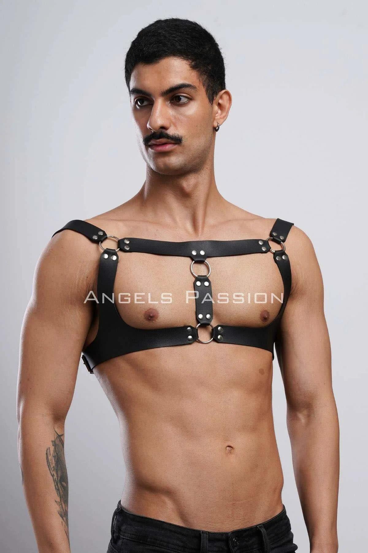 Black chest harness with stacked O-ring center detail worn over bare torso, festival fashion accessory