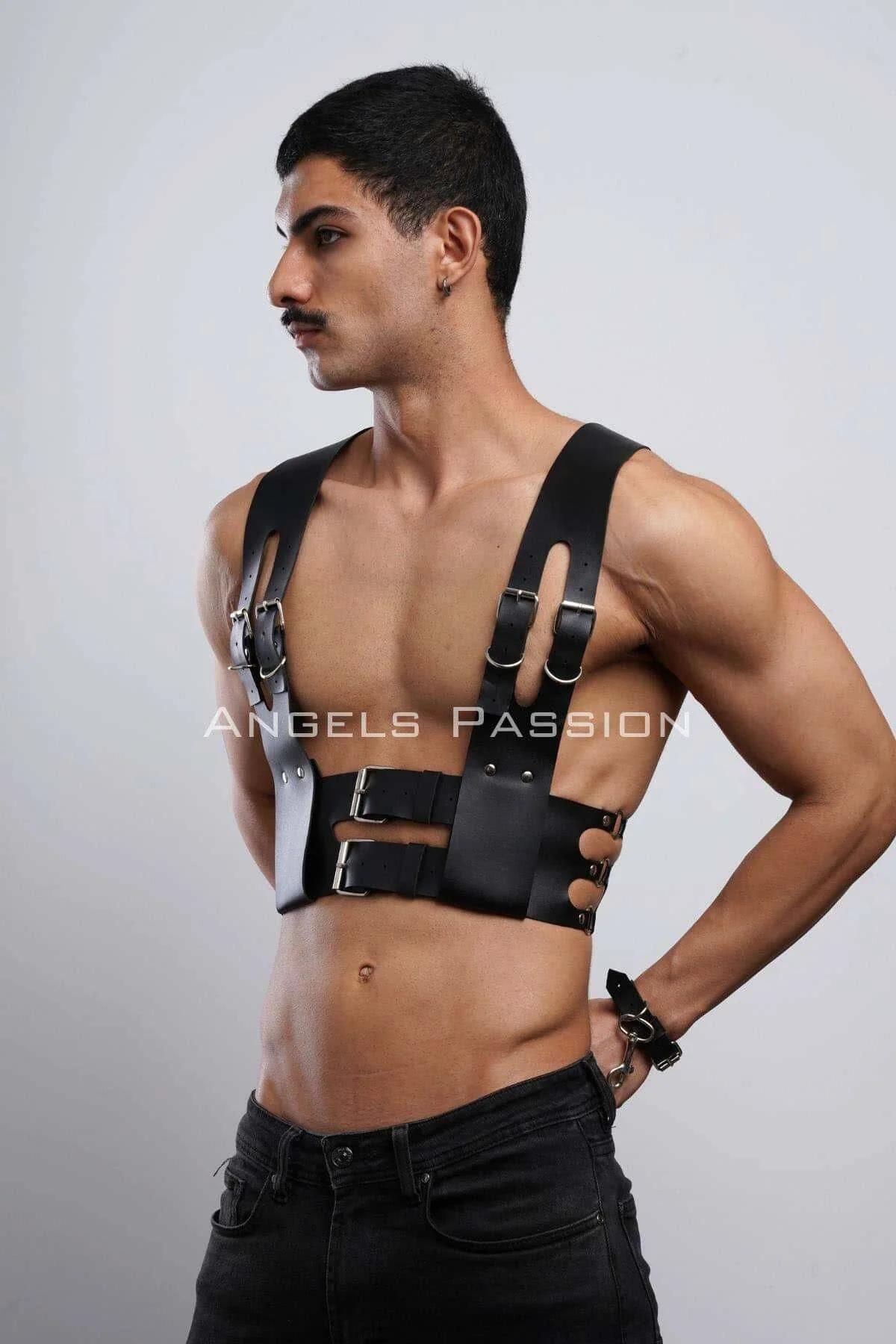 Detail of decorative cut-out slots on 3 cm wide black faux leather shoulder straps of mens harness