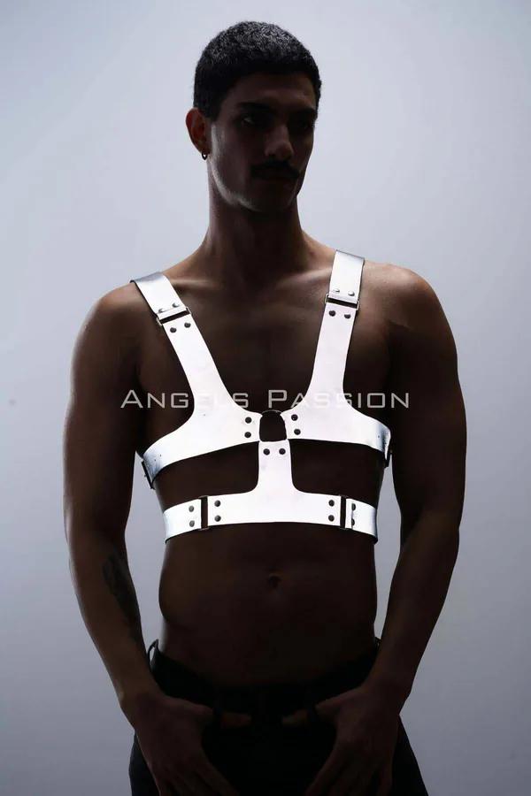 Reflective white chest harness with wide adjustable straps and silver rivets worn by a man front view