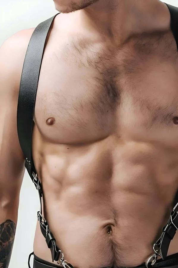 Black faux leather men's body harness with wide shoulder straps and silver swivel snap hooks and D-rings at chest and waist