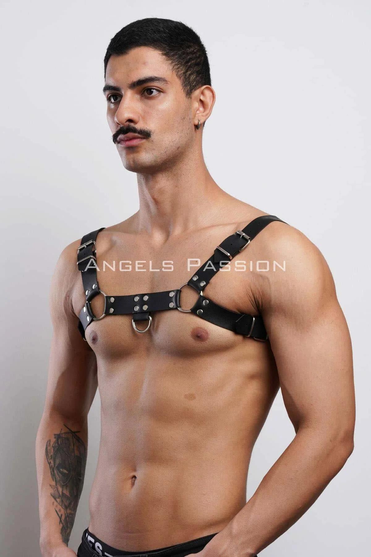 close-up of dual silver O-rings and rivet studs on black faux leather chest band