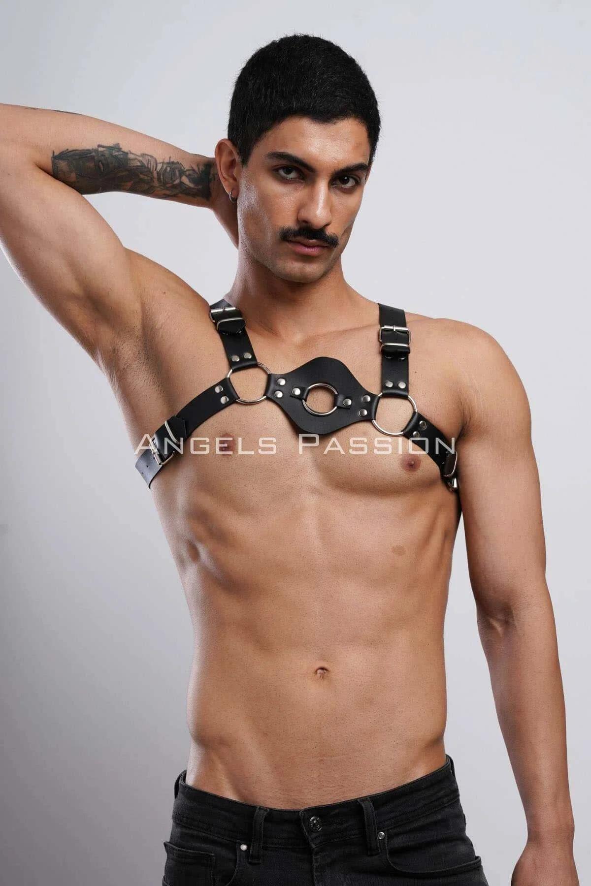 close-up of three silver-tone O-rings on black chest panel harness with rivet hardware