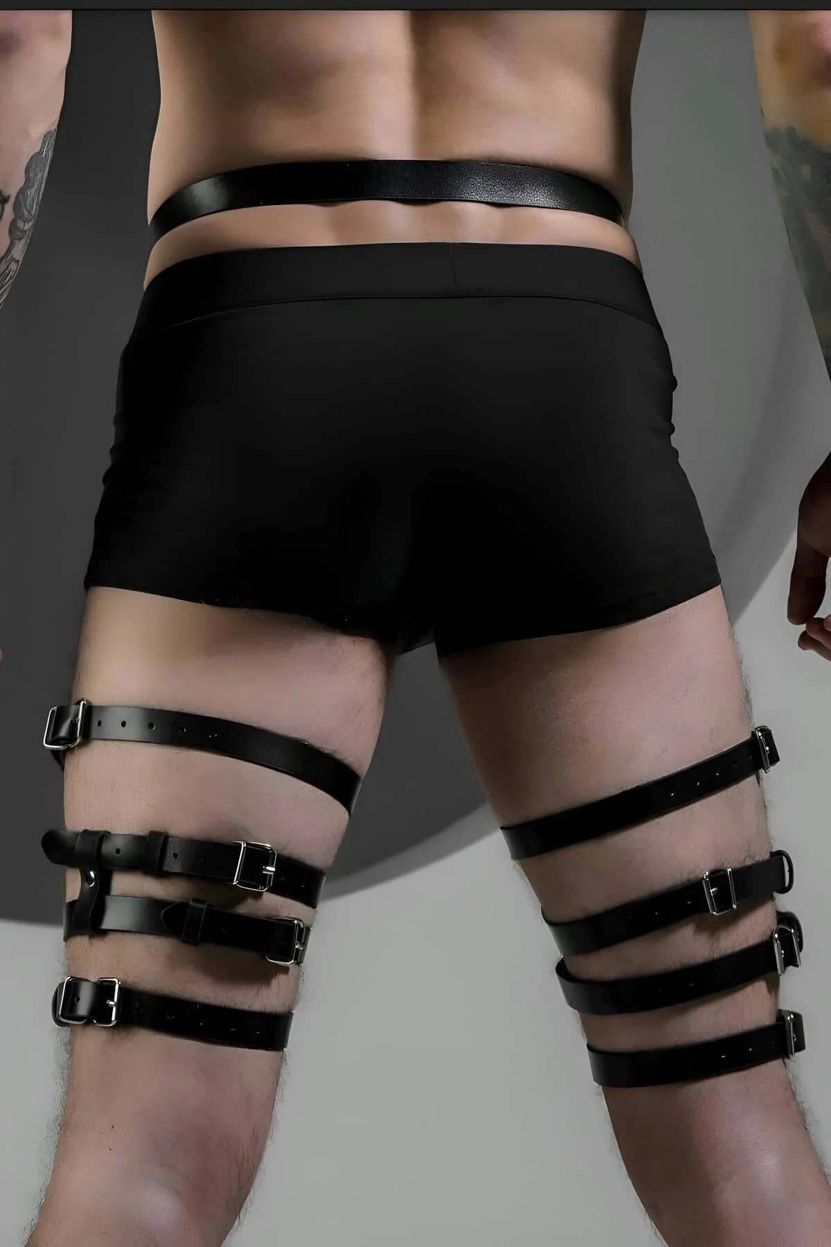 close-up of gunmetal O-ring and buckle detail on black faux leather thigh harness