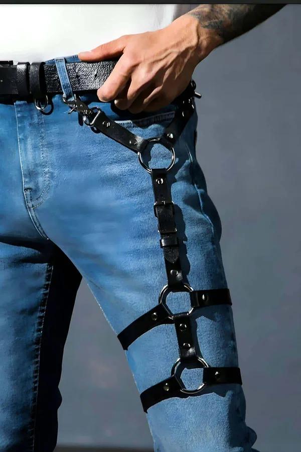 black faux leather thigh harness with three gunmetal O-rings worn over blue jeans clipped to belt