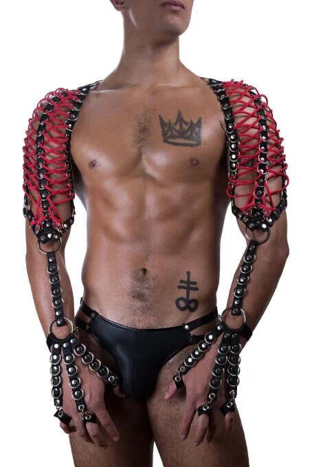 Red faux leather shoulder harness black chain lattice panels silver O-rings wrist cuffs worn by male model