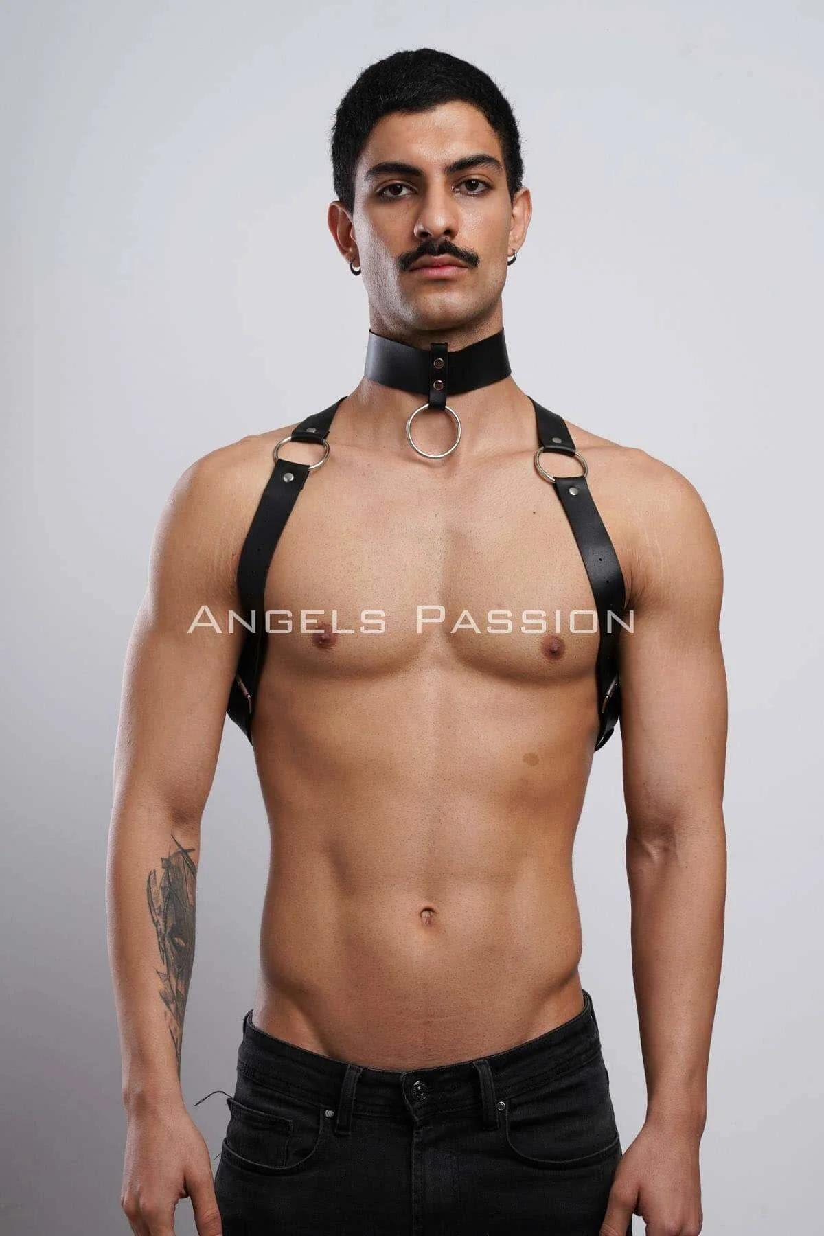 Close-up of silver O-ring detail on black faux leather chest harness center connection