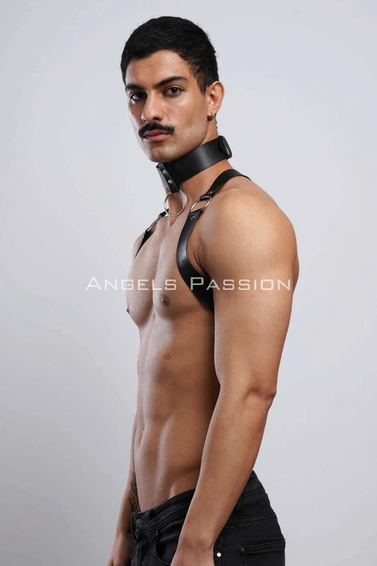 Male model wearing black choker chest harness over black jeans, full front silhouette
