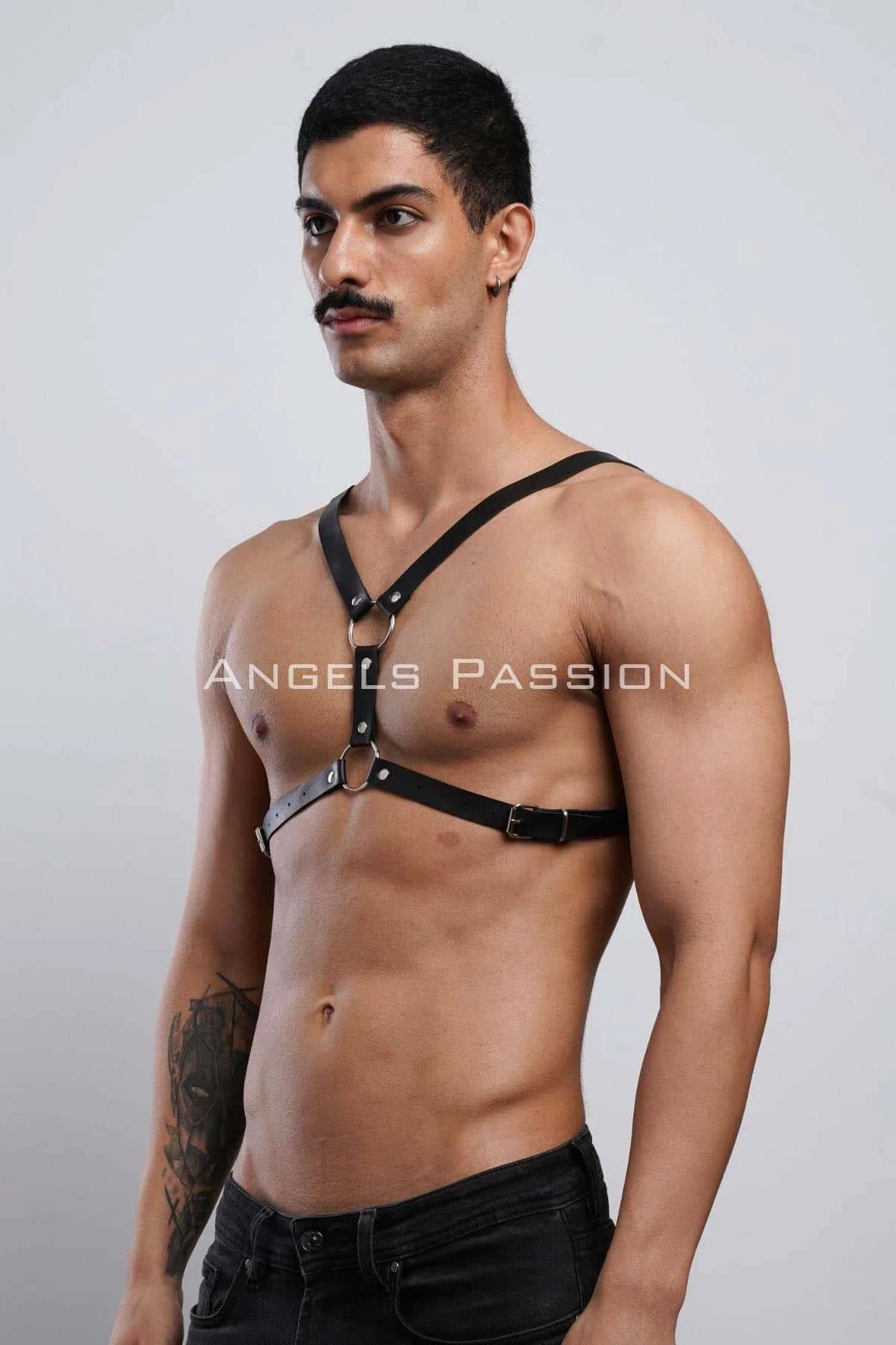 close-up of silver O-ring detail on black vegan leather chest harness Y-strap junction