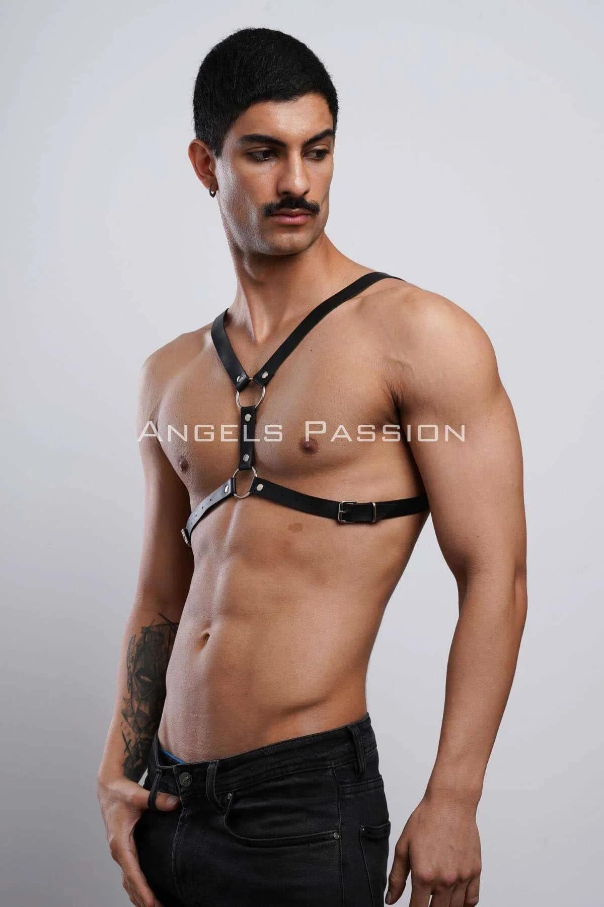side view of black faux leather chest harness showing pin buckle adjustment on lower band