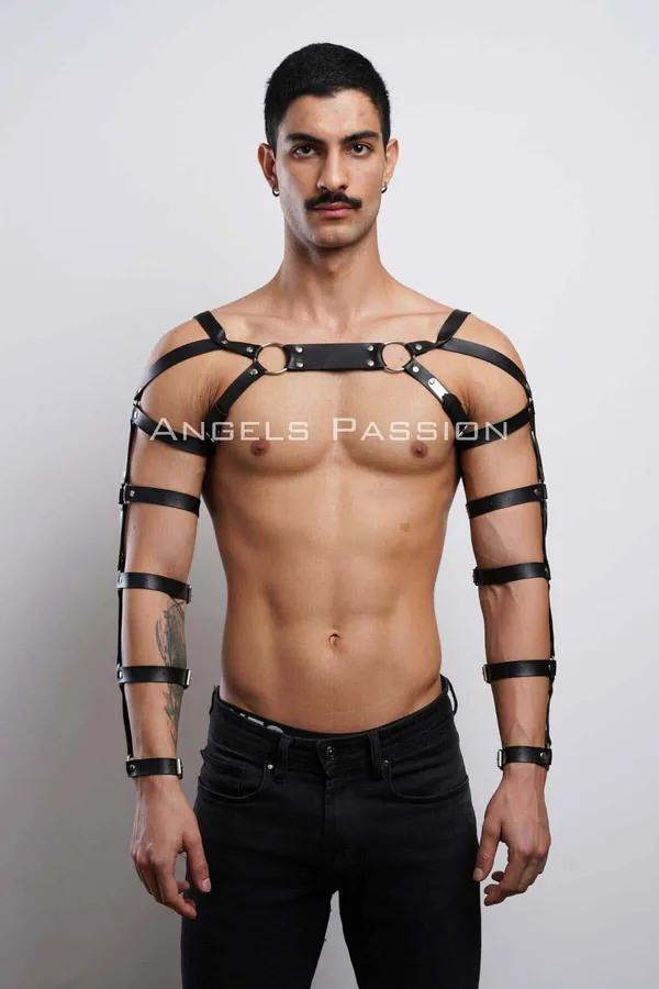 Black faux leather chest harness with four multi-band arm straps and silver O-rings worn by male model