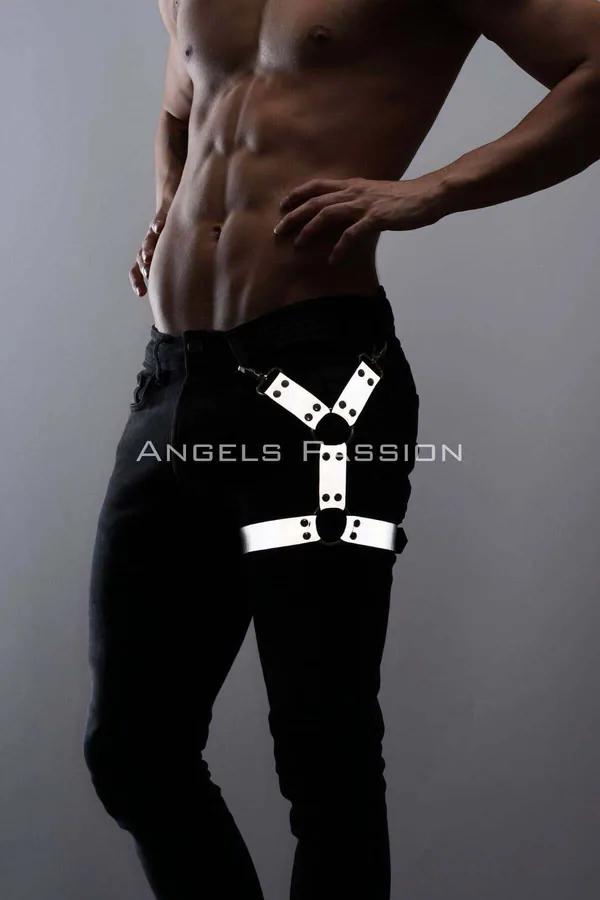 White reflective O-ring leg harness strap worn over black jeans with silver snap hardware on upper thigh