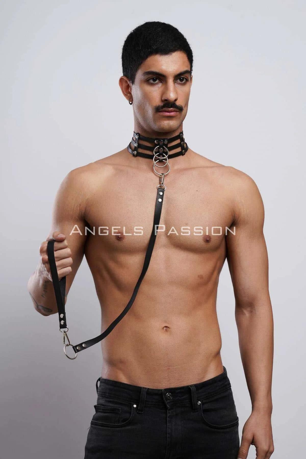 Black faux leather triple-strap o-ring choker with detachable silver snap-clip leash worn on male model