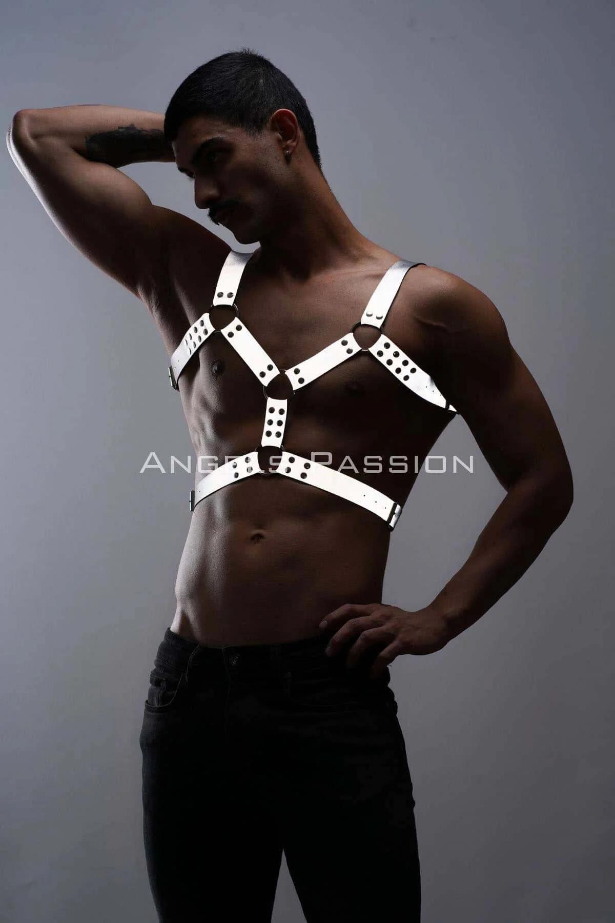 Close-up of black zinc alloy O-ring and snap stud detail on white reflective harness strap